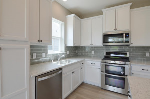 Photo for 13205 Deerwood Lane N, Dayton, MN 55327 - Listing #6097796 Stunning AND functional all in one, as the kitchen space features a pantry cabinet for help with storage, countertops coated in Quartz and a glass tile backsplash the perfect touch of color! (Photo of same plan, colors are similar)