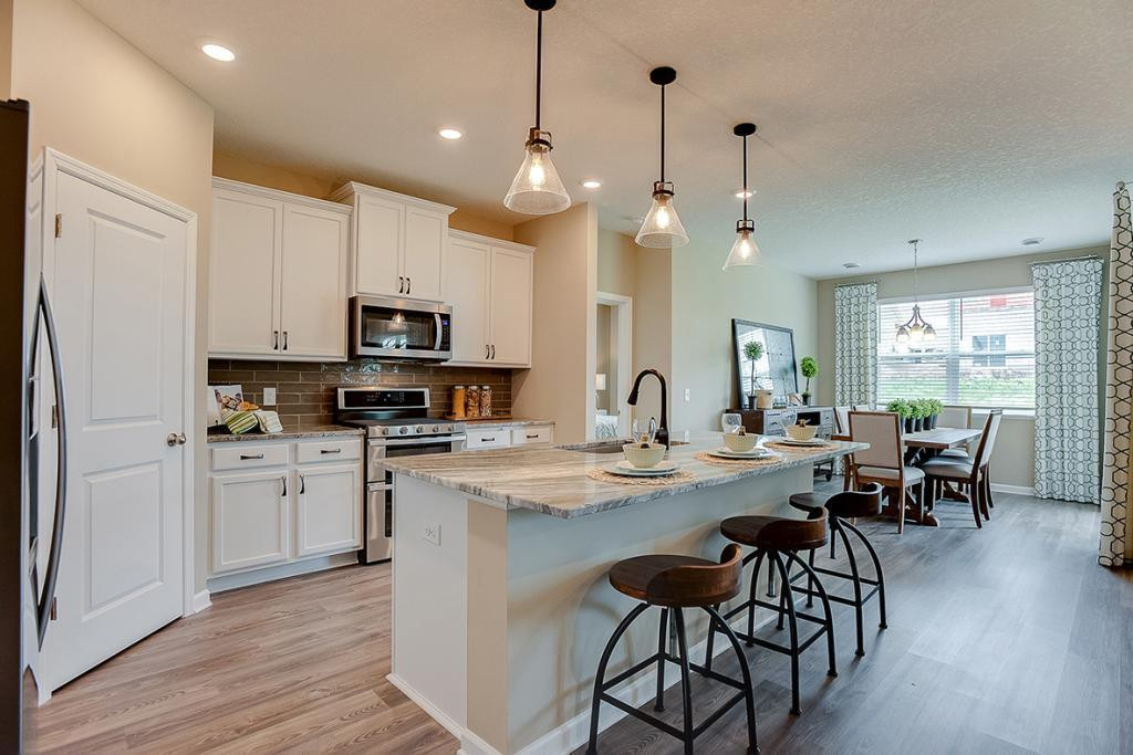 Photo for 13633 Applewood Trail, Rosemount, MN 55068 - Listing #6098803 An elegant combination of quartz countertops and while enameled maple cabinets help bring to life a kitchen that will prove to be every bit as functional as it is beautiful. *Photo of previous model, selections will vary.