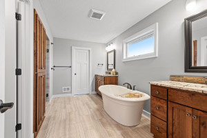 Photo for 11610 Aster Lane, Woodbury, MN 55129 - Listing #6114865 The spa-inspired master bath features his and hers vanities with granite countertops, free-standing soaking tub, compartmentalized toilet, large walk-in shower and built-in cabinets.