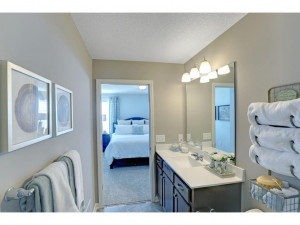 Photo for 345 Freedom Lane, Delano, MN 55328 - Listing #6127490 Here is a peak at the primary bath, which features a vanity top with loads of counter space and an over-sized walk-in shower. Photo of model, colors will vary