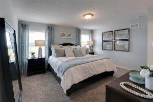 Photo for 345 Freedom Lane, Delano, MN 55328 - Listing #6127490 Another view of the primary bedroom - shown furnished with a king-sized bed! Photo of model, colors may vary