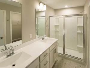 Photo for 7294 Bunker Lake Boulevard NW, Ramsey, MN 55303 - Listing #6123436 Photo of a different home with similar floorplan. Finishes and options may vary. Owners bath features double sink vanity, spacious shower, and separate water closet.