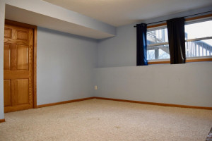 Photo for 16755 Mankato Street NE, Ham Lake, MN 55304 - Listing #6124165 Lower level family room with lookout windows and pocket door that leads to laundry room.