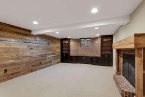 Photo for 3530 Edmund Boulevard, Minneapolis, MN 55406 - Listing #6205579 The family room is warm and welcoming, and boasts neutral carpet, a rustic wood paneled accent wall, and a wall of built-ins.
