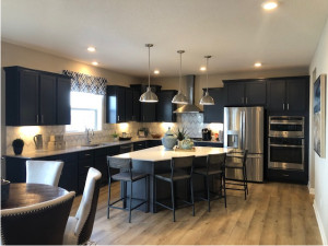 Photo for 4785 Stable View Drive, Woodbury, MN 55129 - Listing #6163264 Wonderful Gourmet Kitchen with blue cabinets at the perimeter and stained cabinets at the large island. Appliances are stainless steel cooktop, hood, wall ovens, dishwasher and French Door fridge. Cabinets includes soft close drawers & doors.
