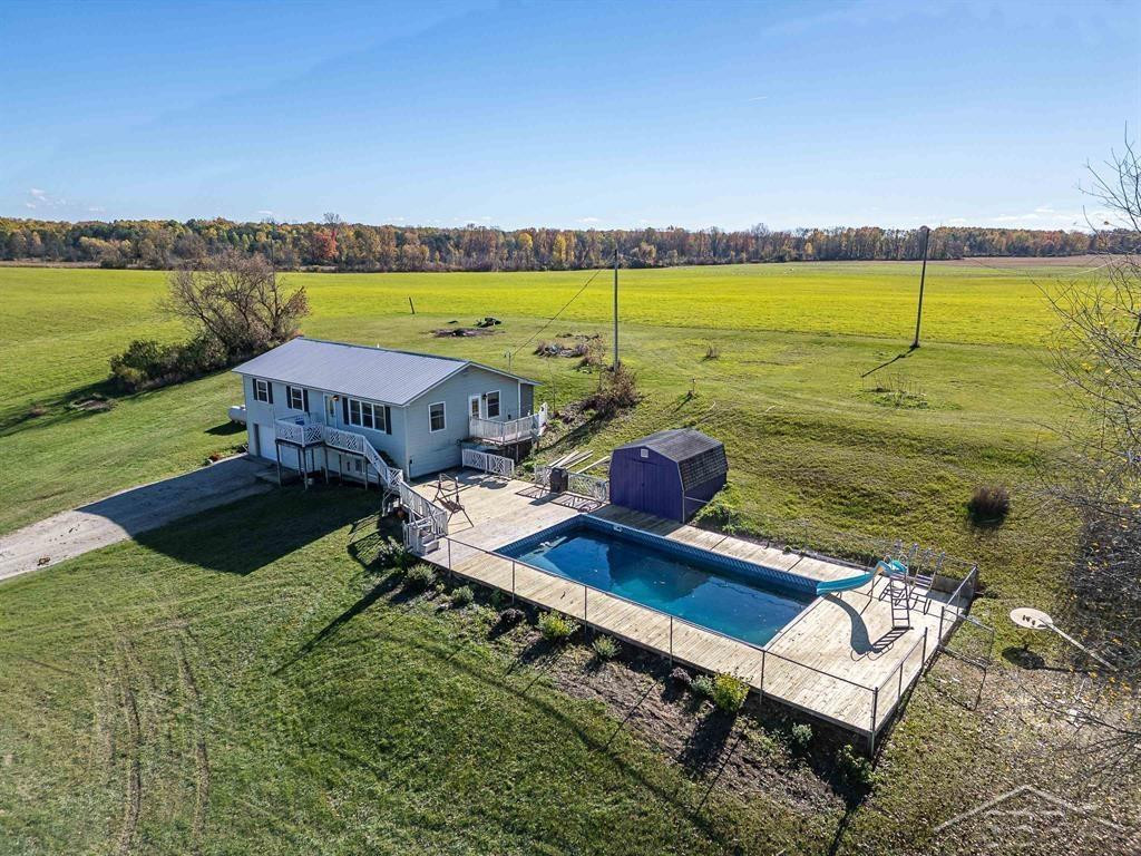 8100 E Grass Lake Road, Clare, MI 48617 — front exterior