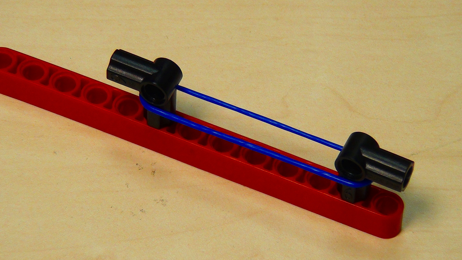 FLLCasts Rubber bands LEGO robot attachment triggered with a motor