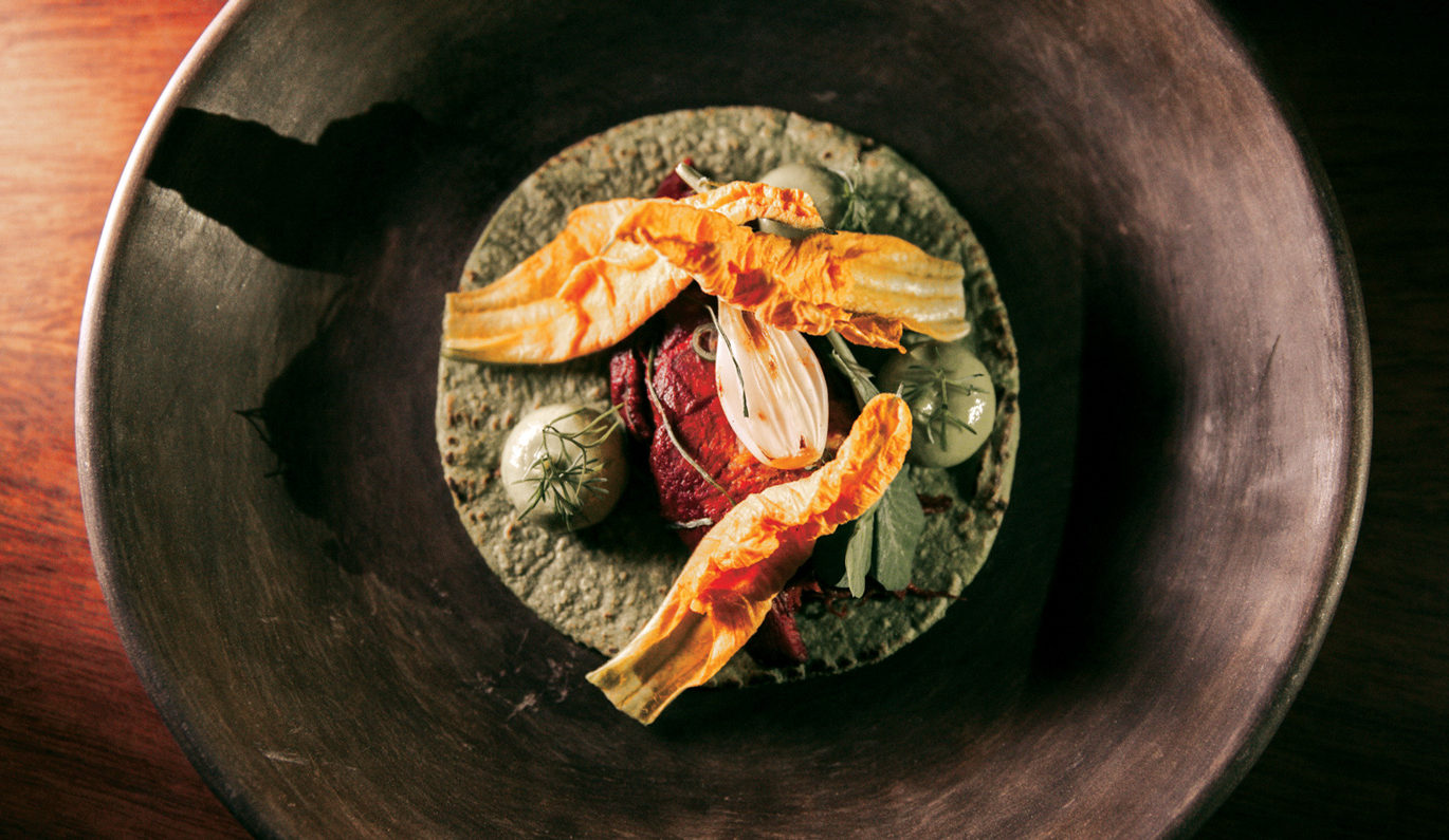 A refined plated dish at Pujol during the Fluenz Spanish Immersion in Mexico City, showcasing the extraordinary culinary experience that complements the program’s intensive, high-level Spanish learning.
