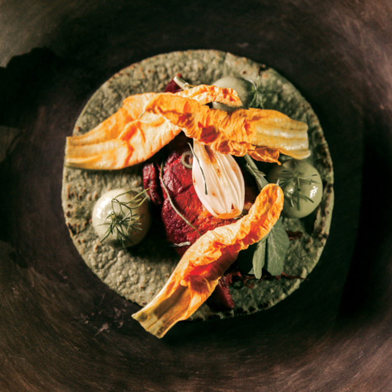 A refined plated dish at Pujol during the Fluenz Spanish Immersion in Mexico City, showcasing the extraordinary culinary experience that complements the program’s intensive, high-level Spanish learning.