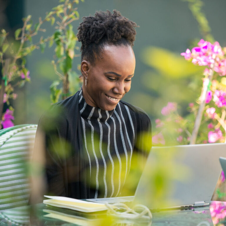 Professional woman engaged in a personalized Fluenz Live Online Spanish class via Zoom, practicing language skills in a supportive one-on-one coaching session.