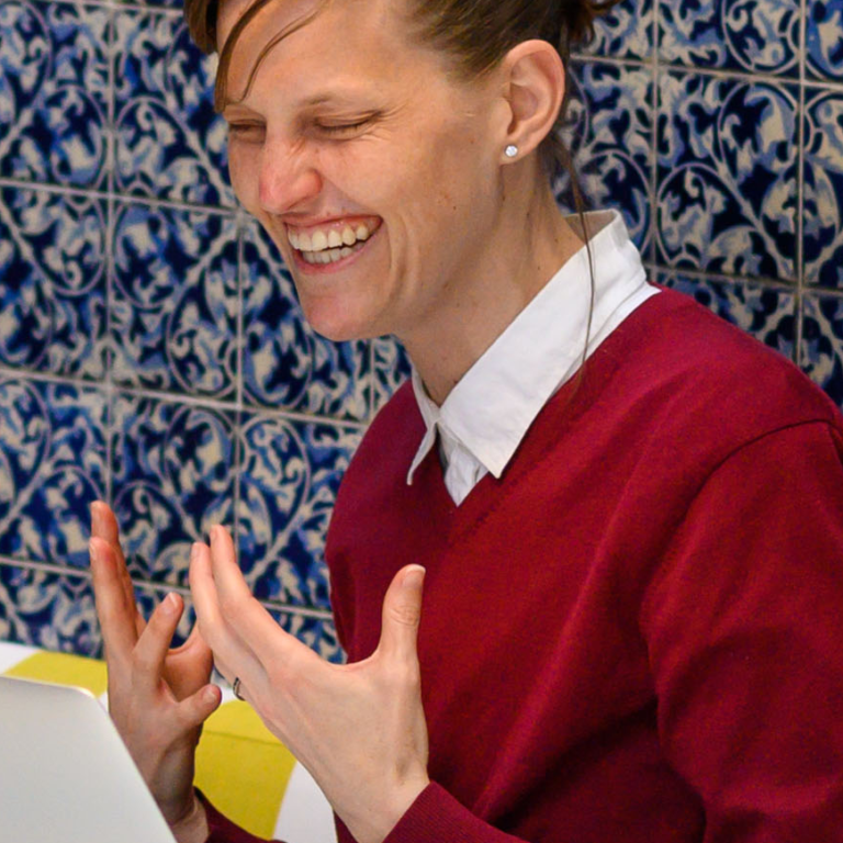 Spanish tutor from the Fluenz Online Spanish Immersion program engaging in a dynamic live session with an adult learner, combining personalized Spanish instruction and real-time coaching for professional fluency development.