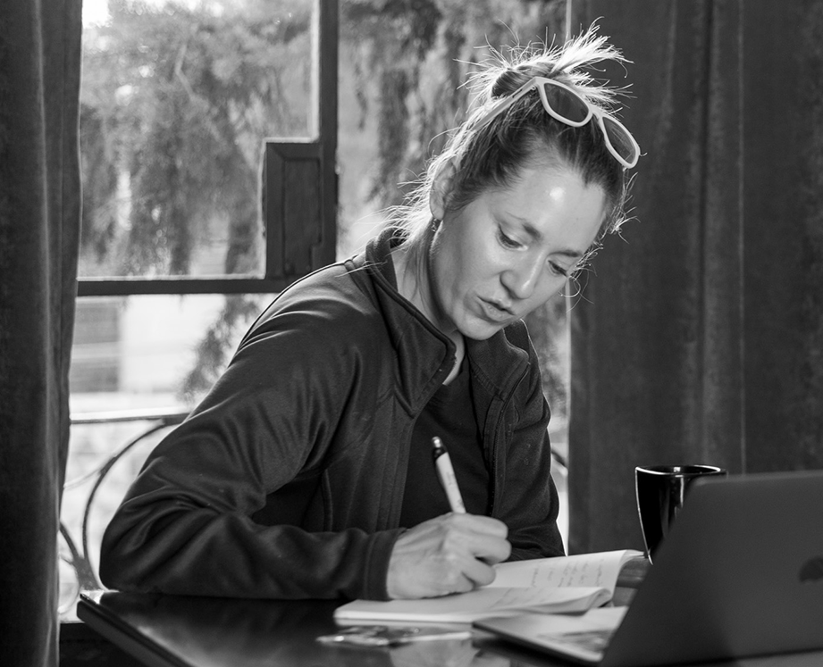A learner participating in the Fluenz Online Spanish Immersion program, taking notes during a one-on-one virtual session with a Spanish tutor, designed for professionals who want to learn Spanish online or learn Spanish via Zoom with a personalized, high-touch approach.