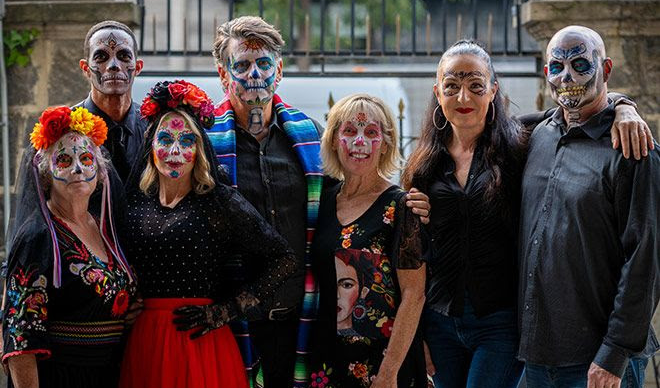 A group of Fluenz Spanish Immersion students in Mexico City celebrates Día de los Muertos with traditional face paint and attire. The image captures the cultural depth and community spirit of the best program to learn Spanish in Mexico, where language learning is intertwined with authentic local traditions.