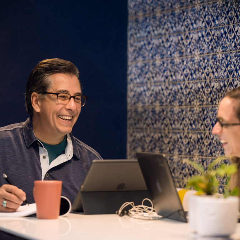 Fluenz Spanish Bootcamp in Mexico City with an adult learner in a one-on-one session with a Fluenz Spanish tutor, working over tablets in a refined Polanco setting. The image shows the most effective and intensive Spanish learning in Mexico City, highlighting personalized coaching, elite instruction, and the best program to learn Spanish in Mexico.