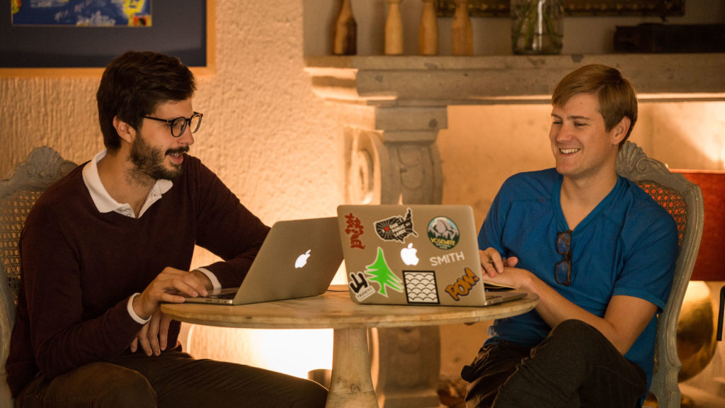 Fluenz Spanish immersion in Mexico City, combining intensive one-on-one Spanish education with real cultural experiences, as adult learners study together on laptops in a historic Mexico City setting, blending structured language learning with daily life and culture.