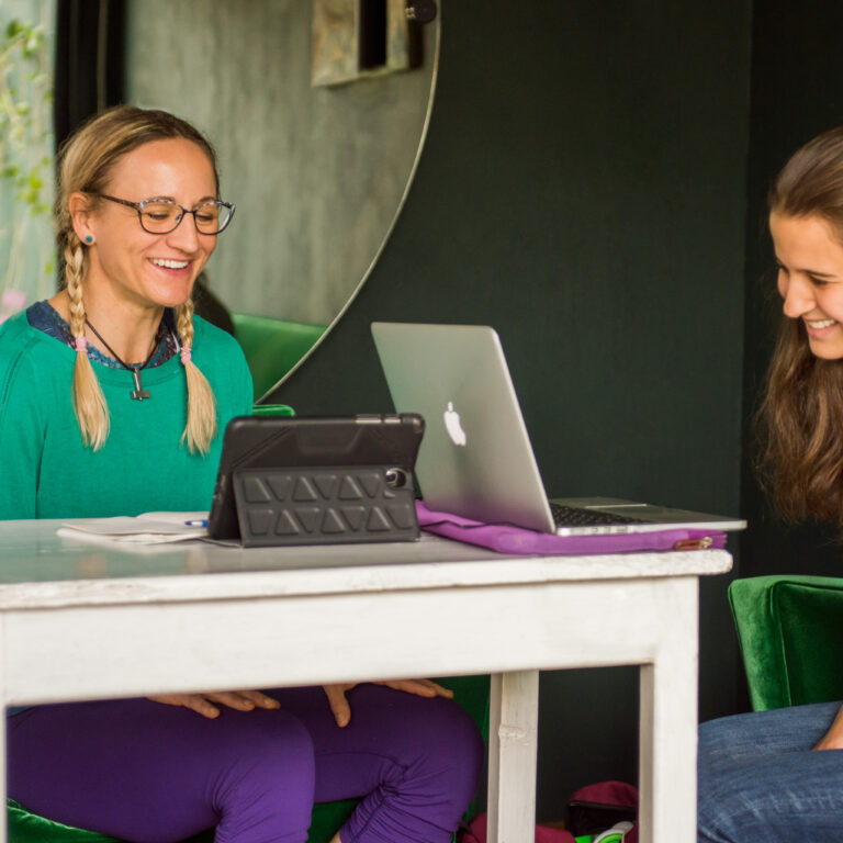 Adult learner and Fluenz Spanish tutor engaged in a one-on-one session during the Fluenz Spanish Bootcamp, a highly structured and intensive Spanish immersion program focused on personalized instruction and measurable fluency for adults.