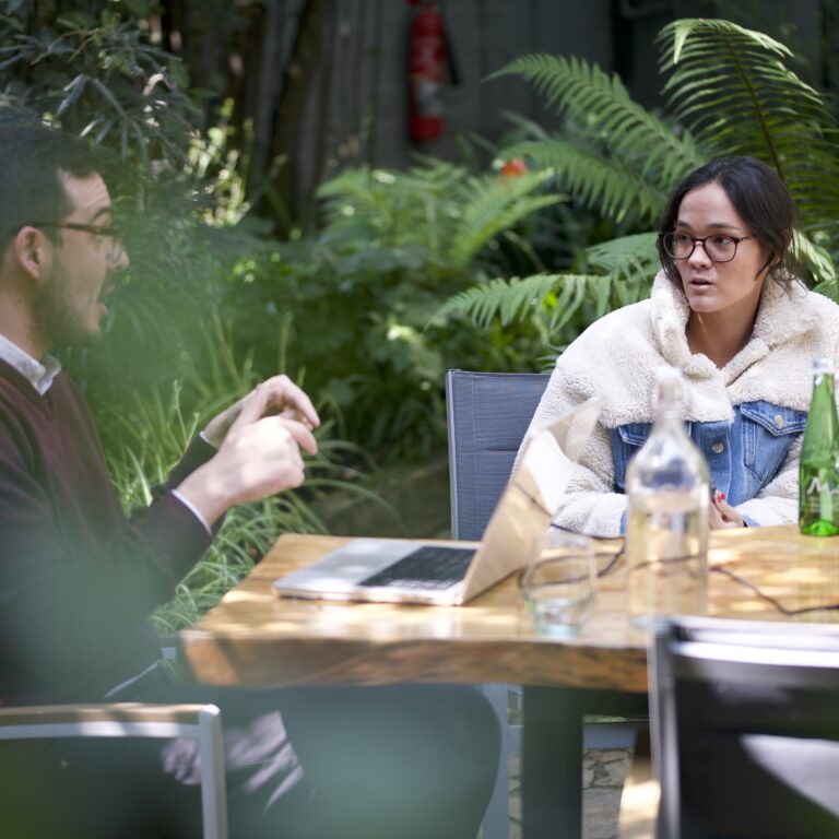 Adult learner and Fluenz Spanish tutor in a one-on-one coaching session outdoors, part of the Fluenz Spanish Bootcamp—an intensive, highly structured Spanish immersion program designed for adult learners.