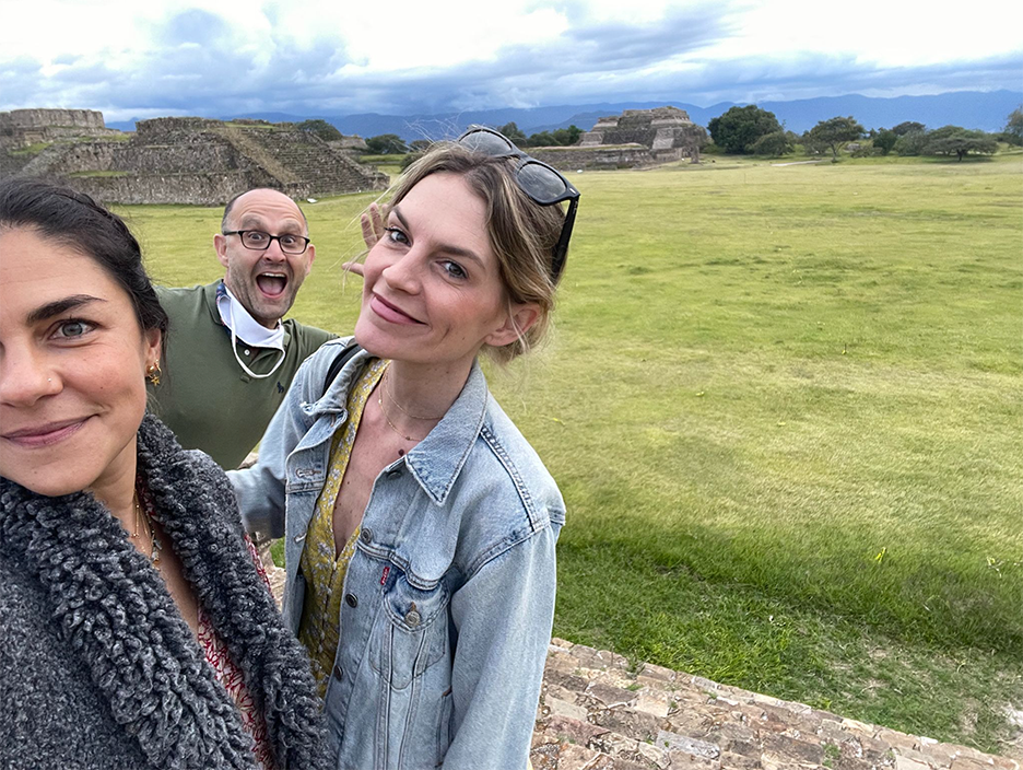 Adult learners take a selfie at the Oaxaca archaeological site during the Fluenz Spanish Immersion, capturing a moment of cultural exploration as part of the immersive learning experience.