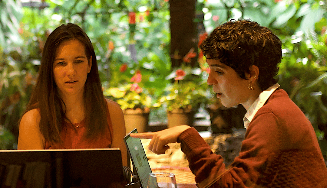 Fluenz Spanish Bootcamp participant works one-on-one with a tutor at a laptop.