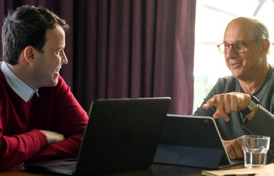 Fluenz Spanish Bootcamp participant practices one-on-one with a tutor using laptops during a personalized lesson.