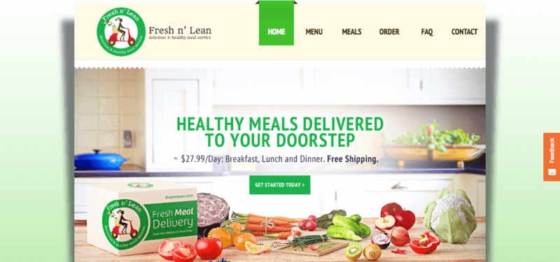 fresh n' lean website screenshot showing a kitchen with the box on the counter and various fruits and vegetables scattered around.