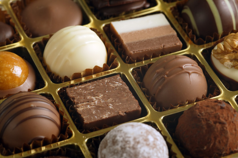 closeup of box of choclates includes white, caramel, truffle, and fudge. This is just one type of chocolate subscription box available.