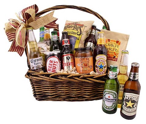 A selection of beers and snacks in a wicker basket with a bow.