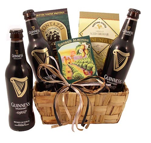 A small cane basket with 3 bottles of Guinness and 3 snacks.
