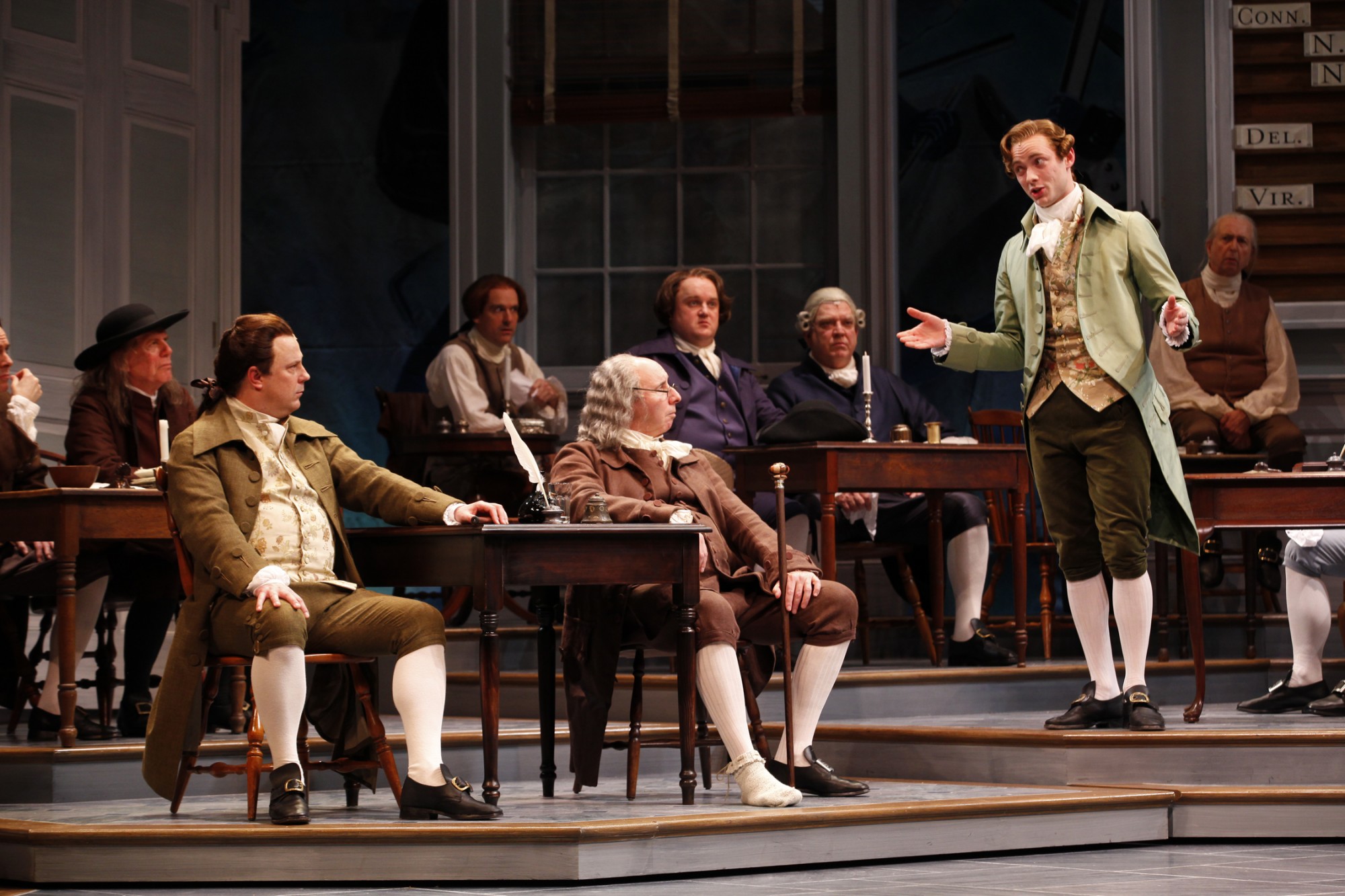 (At Right) Gregory Maheu as Edward Rutledge addresses the Continental Congress in the Ford's Theatre production of “1776,” directed by Peter Flynn.