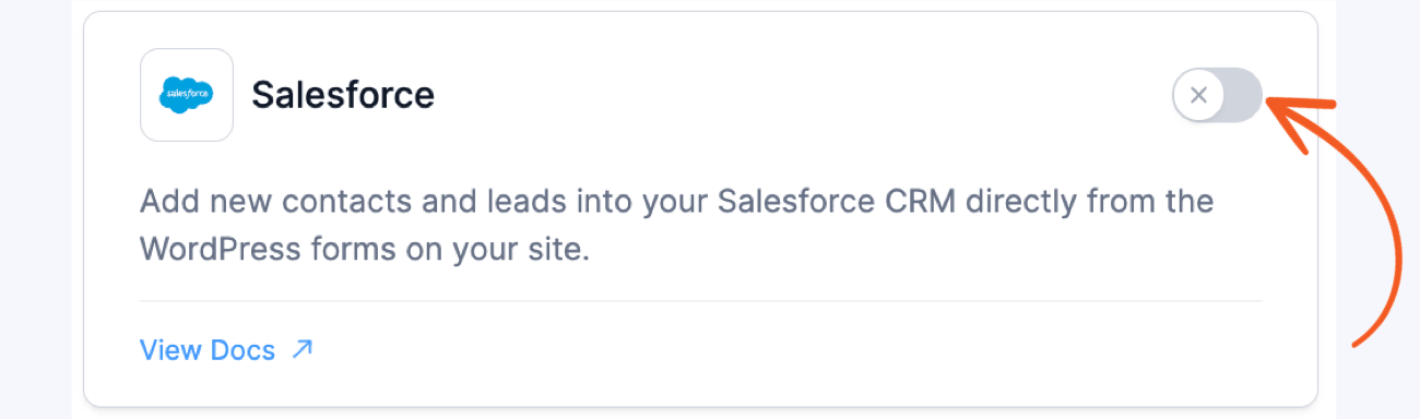 This image features a Salesforce integration option for WordPress forms, allowing users to add new contacts and leads directly into their Salesforce CRM. A toggle switch is shown in the upper-right corner for enabling or disabling the feature, and a "View Docs" link is provided for more information. An orange arrow highlights the toggle button.