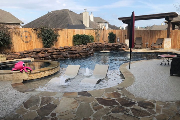 Custom boulder accent around luxury pool in Houston, Texas