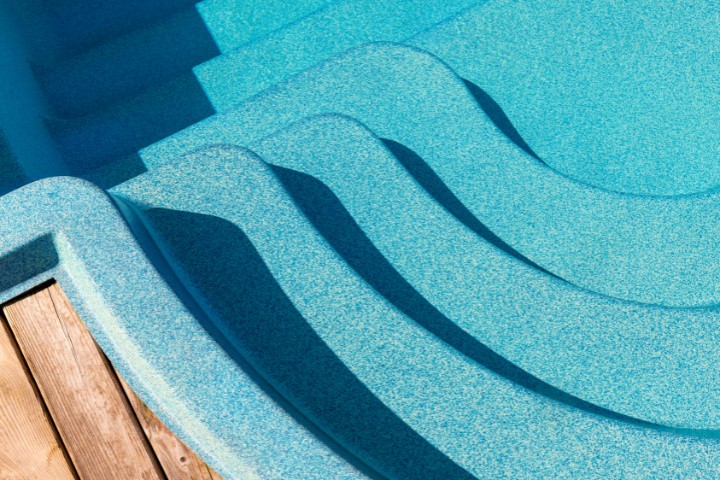 Pre-molded fiberglass pool shell commonly installed for faster completion