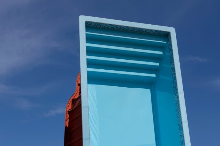 Fiberglass pool shell prepared for installation during the pool construction process.