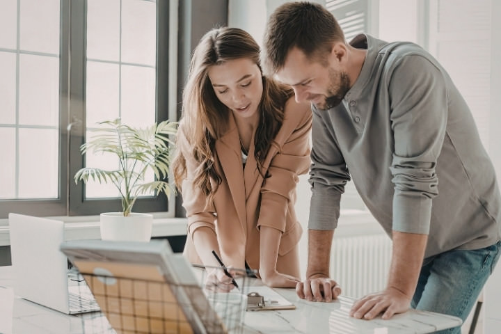 Homeowners comparing costs for a pool rebuild versus renovation project