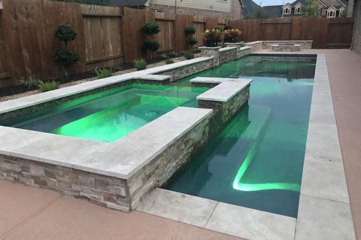 Color changing pool lighting highlights steps and clean geometric lines