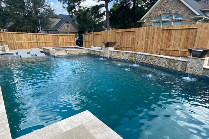 South Texas backyard pool with code compliant wood fencing