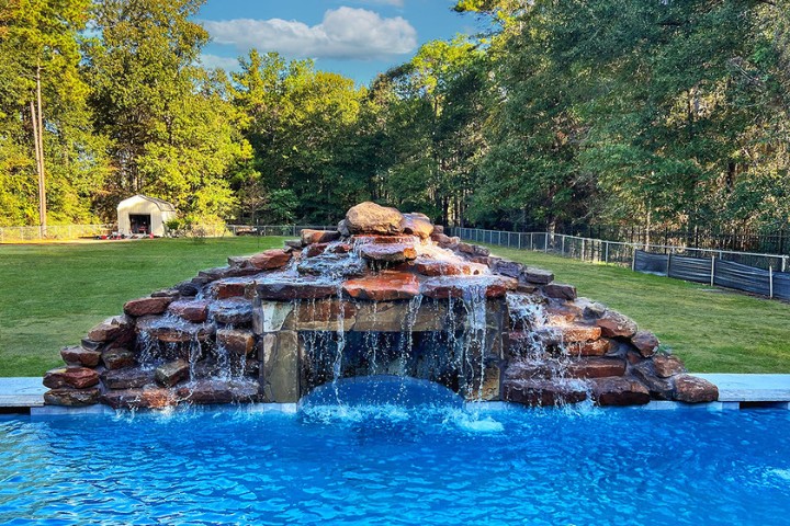Timeless pool accent using layered rock to create water movement and visual interest