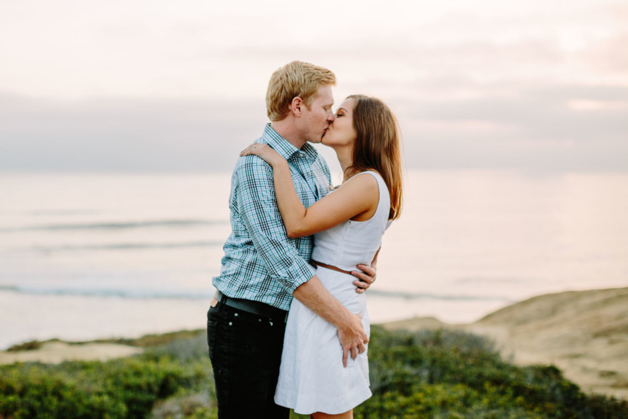 Snuggly Sunset Cliffs Engagement – Photo by Let's Frolic Together