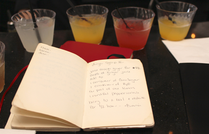 Ackrill keeps her recipes in these two bound notebooks. Yes, those are some of the drinks we sampled in the background.