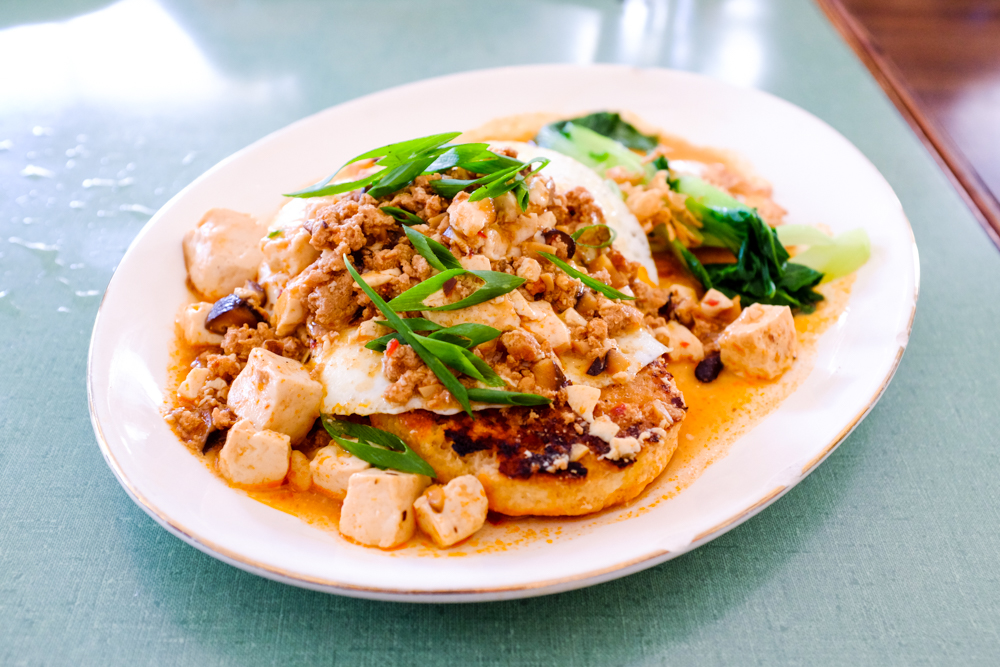 Southern China meets America's South on a plate of biscuit and mapo gravy, made with local pork and tofu with eggs and sauteed bok choy.