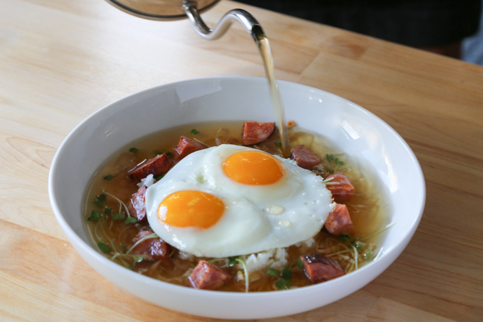 One of the dishes Nik is most proud of is the Kailua eggs ($12). When testing out dishes for the Over Easy menu, he substituted kombu and bonito with bacon and cabbage to create a riff on a classic dashi. To this broth he adds sriracha and sherry vinegar for a light, flavorful broth that is poured over Portuguese sausage, eggs and rice.