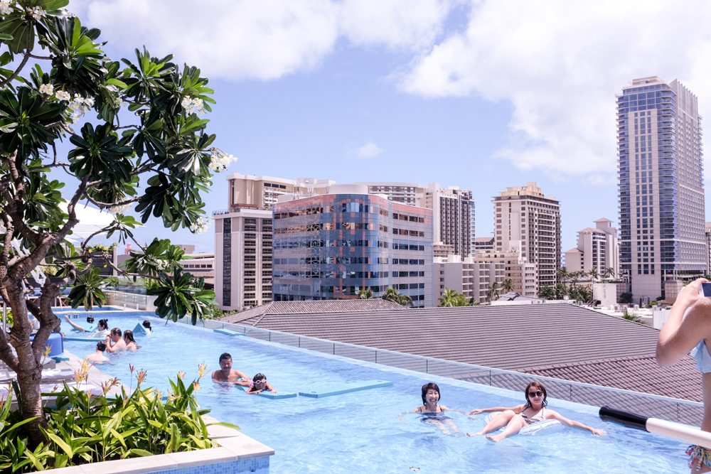 The infinity pool is located just below the restaurant's tall open windows.