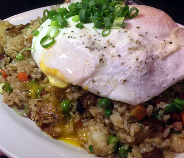 The regular fried rice includes bacon, Spam, Portuguese sausage, peas, carrots, shoyu oyster sauce, sliced white and green onions and two eggs any style. It’s the same as Big John’s Spicy Kim Chee version … just without the added hotness.