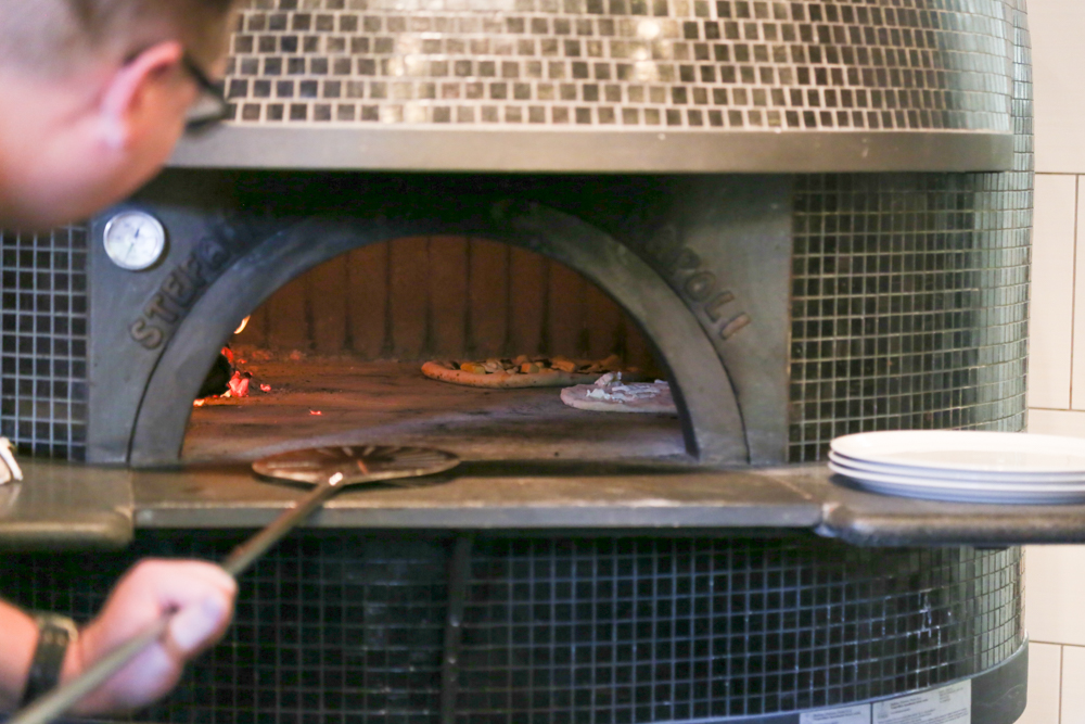 The oven was built piece by piece inside Brick Fire Tavern from materials from Naples, Italy by third generation builder, Stefano Ferrara.