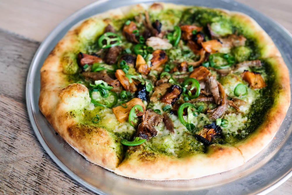The kalua pork pizza ($16) is topped with a house made macadamia nut pesto, chunks of roasted pineapple, jalapeno and pulled kalua pork. This whole pie would be $9 on happy hour.