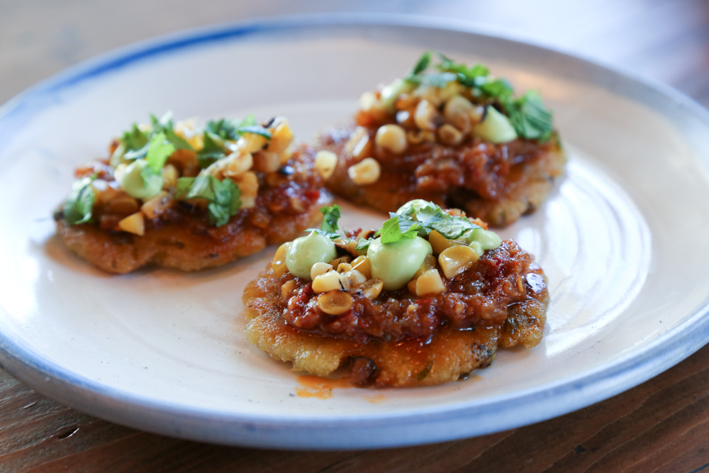 Start your meal with scallion arepas. These thin beauties remind me of Korean chive jun in its base flavor. The app is finished with a huge hit of flavor, topped with anchovy xo sauce, pickled charred corn, avocado crema and cilantro.