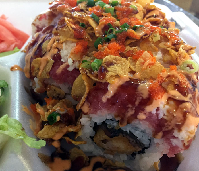 The Honey Roll includes shrimp tempura and eel, and it’s topped with spicy ahi, crab, green onions, masago, the cornflake crunch and three different sauces.