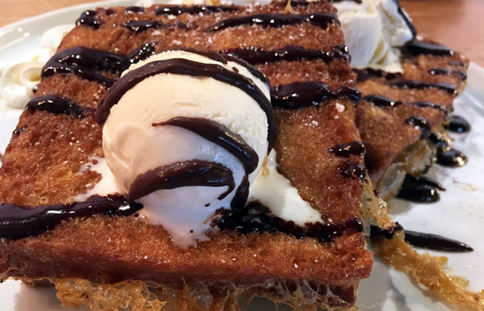 This classic peanut butter sandwich is made with white bread, deep fried and topped with a condensed milk drizzle. Optional: add vanilla ice cream and chocolate sauce for an additional $1.50 … which, of course, I do.
