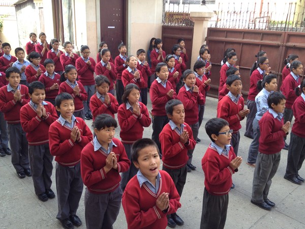 The students reciting prayers at morning assembly The students reciting prayers at morning assembly