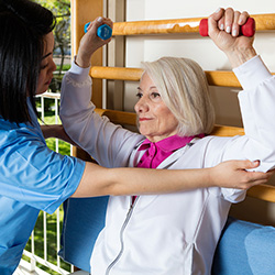 Therapist helping woman with physical therapy